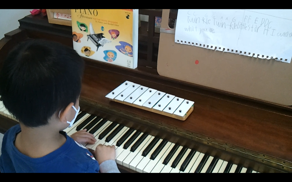 Student at piano with bellsets